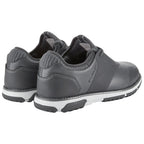 Gray athletic shoes are positioned side by side with a textured heel and white soles showing hints of wear in a neutral setting suggesting a casual or sporty environment.
