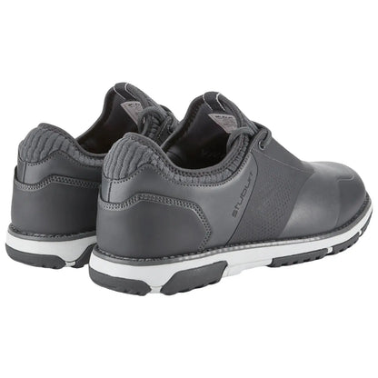 Gray athletic shoes are positioned side by side with a textured heel and white soles showing hints of wear in a neutral setting suggesting a casual or sporty environment.