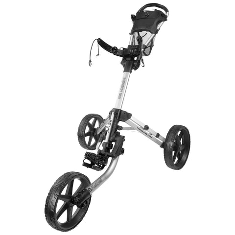 A golf push cart stands upright with three wheels visible. It features a handle on top and a storage compartment. The cart is designed for ease of transport on a golf course.