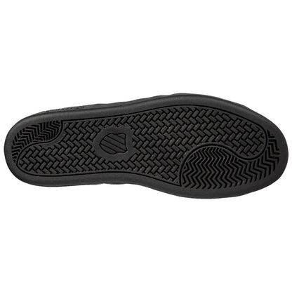 A black shoe sole is displayed showing a textured tread pattern with detailed grooves and a logo in the center indicating it is designed for traction on various surfaces.