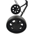 Black wheels are positioned at an angle on a wheeled frame with a sleek, matte finish showcasing circular cutouts and grooves in the rubber tire surface indicating movement potential.