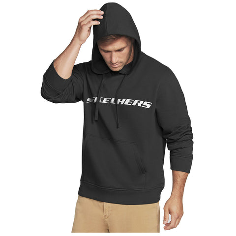 A man wearing a black hoodie with the word Skechers printed in white lowers his head while running his hand through his hair, set against a plain white background.