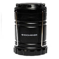 A black lantern stands upright featuring a metallic handle for carrying it The object is designed for providing light in dark environments such as camping or emergency situations