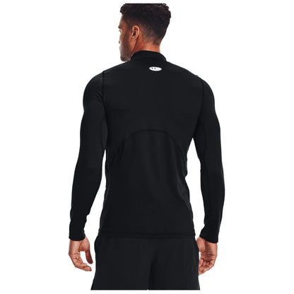 A man stands wearing a fitted black long-sleeve athletic shirt with his back towards the viewer, positioned against a plain white background, emphasizing his sleek silhouette.