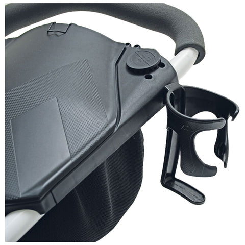 A black stroller accessory attaches to the side holding a cup holder while displaying a textured surface on the main body and a fabric storage compartment below.