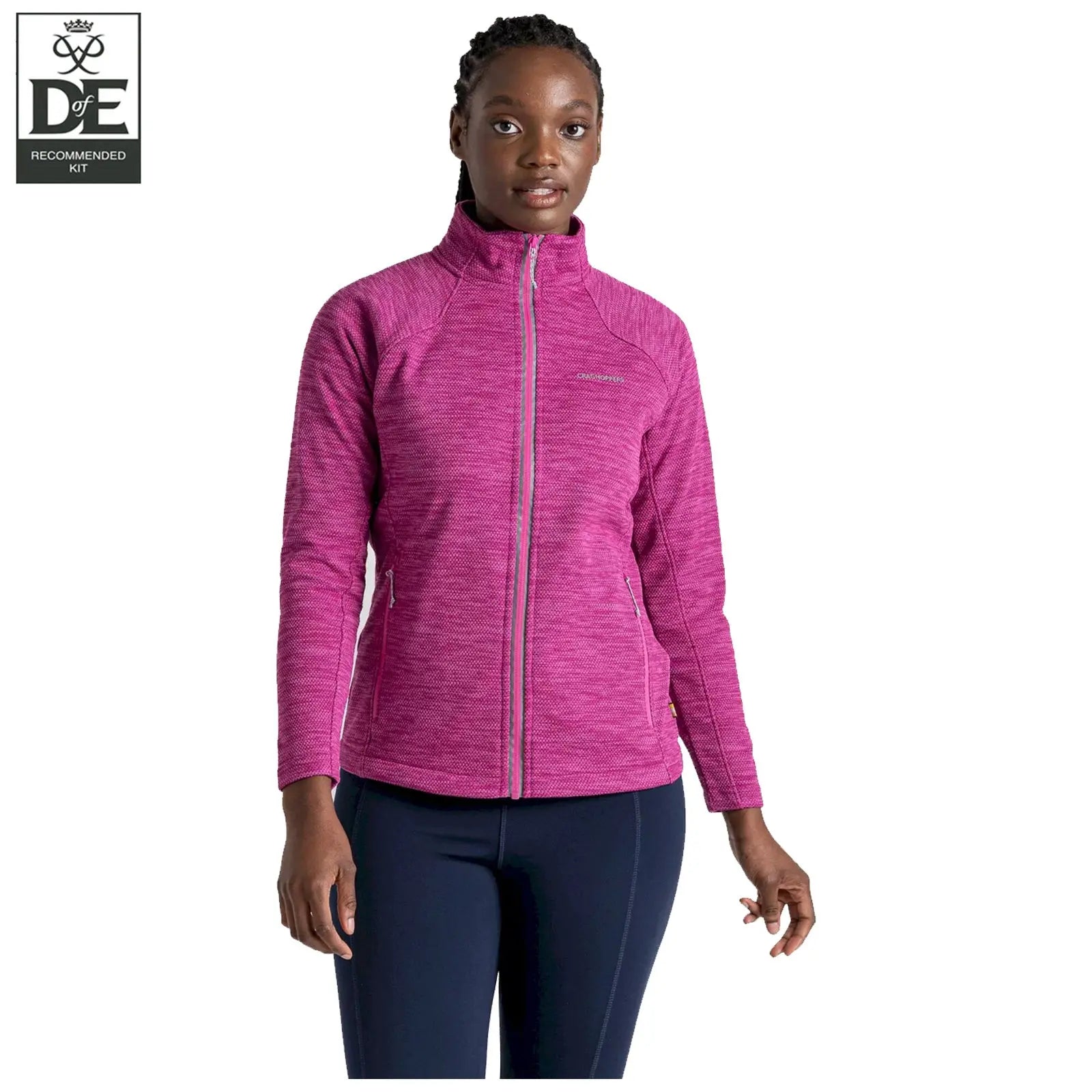 A woman stands confidently wearing a bright pink athletic jacket with a high collar in a neutral setting, showcasing comfort and style suitable for outdoor activities.