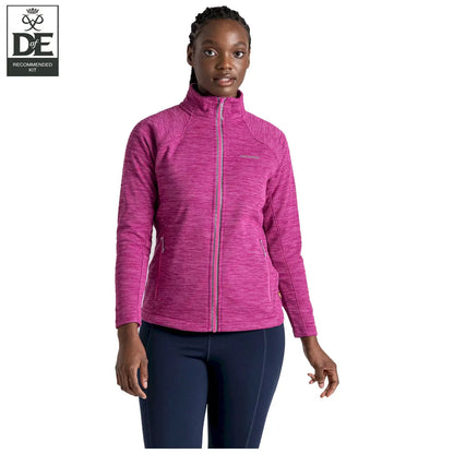 A woman stands confidently wearing a bright pink athletic jacket with a high collar in a neutral setting, showcasing comfort and style suitable for outdoor activities.