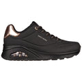 Black sneaker with a sleek design features a glossy copper accent at the heel and a visible air cushion in the sole showcasing the brand name Skechers on the side.