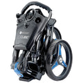 A compact golf trolley is folded and positioned upright with a black frame and blue accents showcasing wheels and handles suggesting ease of transport and storage.