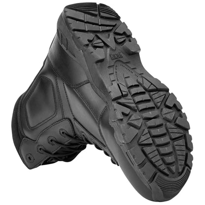 A pair of sturdy black boots is displayed with the soles facing up showcasing a rugged tread design suitable for various terrains in a neutral background environment.