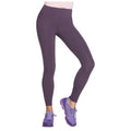 A person is standing with one leg forward wearing dark purple leggings and purple athletic shoes in a neutral setting typically associated with fitness or casual wear.