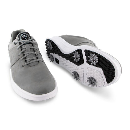 A pair of gray golf shoes is displayed with one shoe facing forward and the other slightly turned revealing a spiked outsole designed for traction on the course.