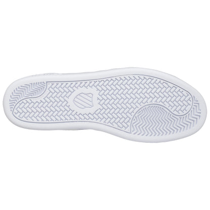 A white sneaker's sole features a textured pattern designed for traction the clean underside is shown against a plain background emphasizing its sleek design and functionality