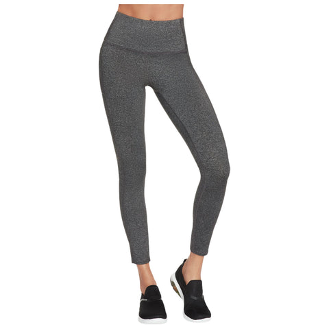 Gray leggings are being worn by a person standing upright showcasing a high waistband and a fitted design paired with black athletic shoes in a neutral background setting.