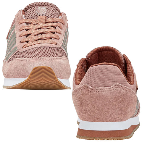Footwear designed for athletic use displays a two-tone pink and gray color scheme featuring mesh and suede materials showcasing laces and a patterned sole on a neutral background.