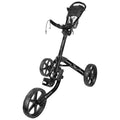 A black golf push cart stands upright with three wheels and a handle. It is designed for transporting golf bags on the course.