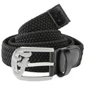 A black woven belt is coiled with a shiny silver buckle showcasing a decorative logo and a leather end piece providing a sleek contrast in a neutral setting.