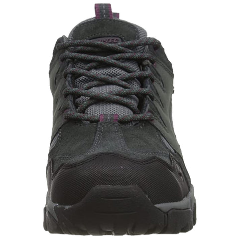 A black and gray hiking shoe is shown positioned upright with laces tightly secured against a neutral background emphasizing its sturdy construction and outdoor suitability for various terrains.