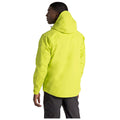 A person is standing with their back to the viewer wearing a bright yellow jacket with a hood in a plain background suggesting a focus on the apparel rather than the individual.