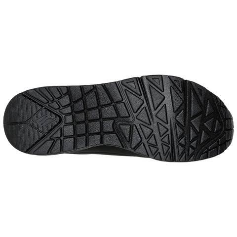 A black sneaker sole is displayed with a textured tread pattern designed for traction on various surfaces showcasing grooves and raised sections suitable for outdoor activities.