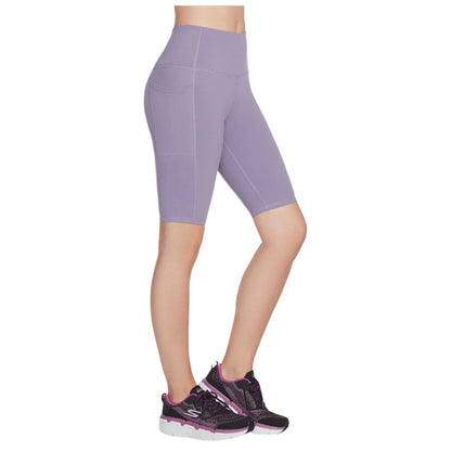 A pair of fitted purple bike shorts is displayed alongside black athletic shoes featuring purple accents the context suggests activewear suitable for exercise or casual use.