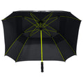 A black umbrella with a green frame is open and positioned upside down showcasing its structure while emphasizing its large surface area designed for rain protection in an outdoor setting.