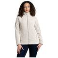 A woman wears a light-colored, zip-up fleece jacket with textured fabric. She stands straight with a neutral expression, hands partially raised, against a plain white background.