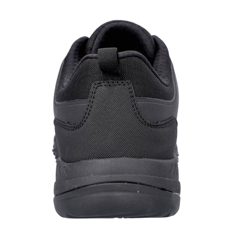 A black athletic shoe stands upright showcasing its rear view with a textured surface and a slip-resistant sole designed for comfortable wear in various environments.