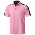 A short-sleeved polo shirt is displayed with a soft pink front and dark navy sleeves. It features a collar with buttons and a logo on the left chest area.