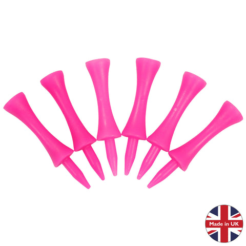 Six pink golf tees are arranged with pointed ends facing downward suggesting they are ready for use in a golf game on a surface intended for placing a golf ball.