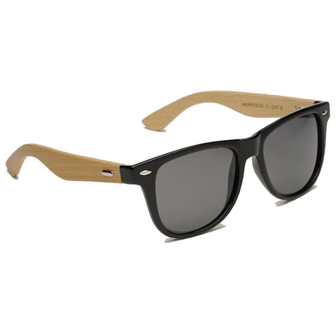 Sunglasses featuring black lenses and a black front frame are resting with wooden arms designed for style and comfort showcasing an accessory ideal for sunny outdoor environments.