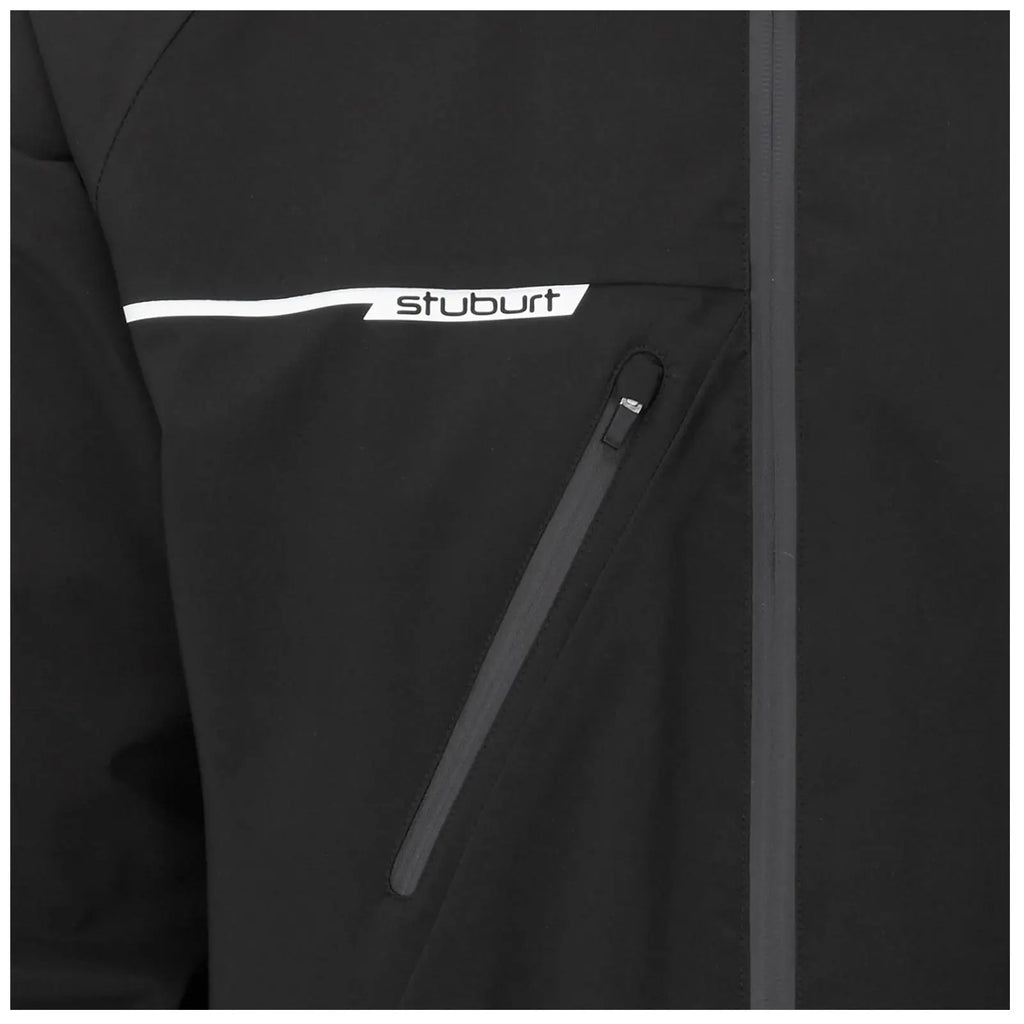 Black jacket with a zipper pocket displays a white logo labeled stuburt on the chest area highlighting its sporty design and functionality in an outdoor context.