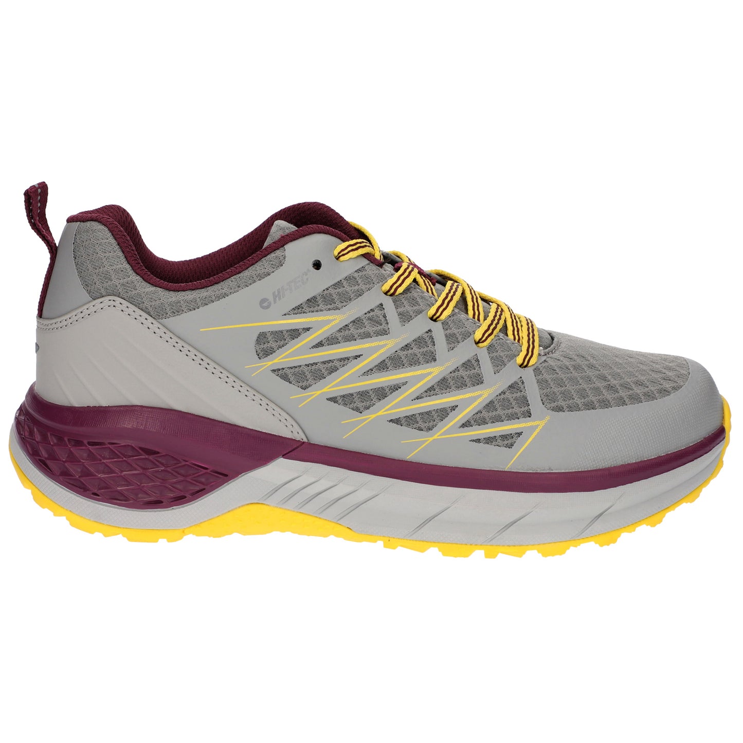 A gray athletic shoe with yellow laces and maroon accents is displayed standing on a white background showcasing its design and texture, suitable for outdoor activities.