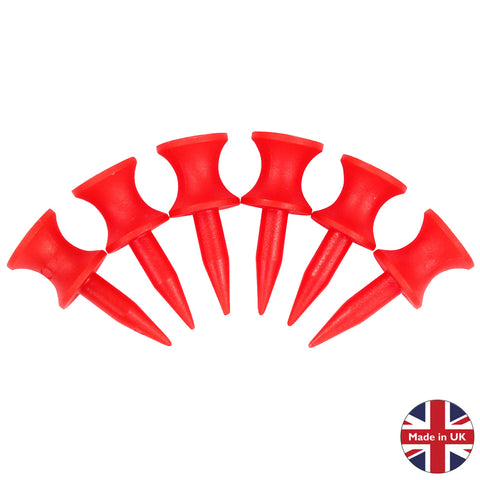 Six red golf tees with pointed ends are arranged in a slightly curved line on a white background next to a circular label that says Made in UK with a union jack design