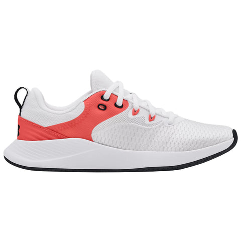 A white athletic shoe with a coral accent is positioned sideways displaying its design and structure suited for movement and exercise in casual or sports environments.