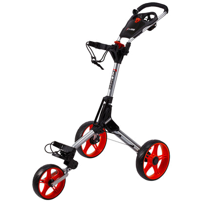 A golf push cart with a metallic frame and red wheels is positioned upright. It has a handle for steering and compartments for holding golf bags and accessories, suitable for use on golf courses.