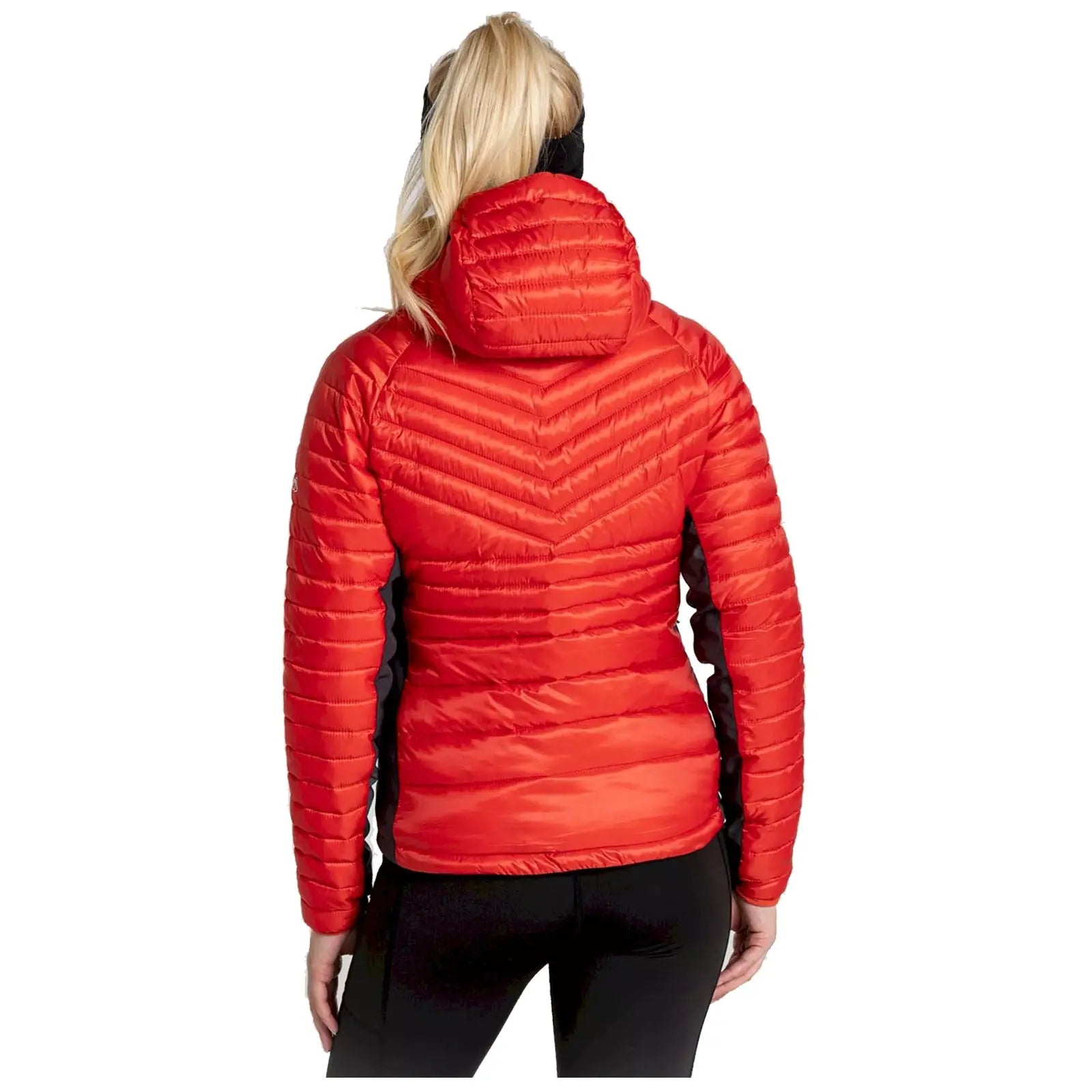 A woman is wearing a red puffy jacket with a hood facing away from the viewer, showcasing the jacket's textured design and vibrant color against a plain background.