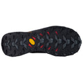 A rugged shoe sole featuring deep treads and a mix of black rubber with red and gray accents rests flat. The design suggests stability and traction for outdoor activities.