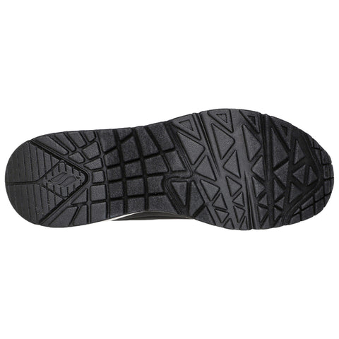 A black athletic shoe sole is viewed from below showcasing its textured surface and tread pattern designed for grip and stability on various terrains.
