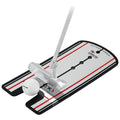 A golf putting aid features a silver putter aligned with a white ball on a flat surface marked with lines for guidance in practice.