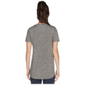 A person is standing with their back facing the viewer wearing a loose-fitting gray short-sleeve shirt that has a rounded hem in a neutral background.