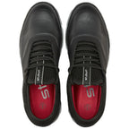 Black athletic shoes are positioned upright showcasing their sleek design with textured sides and black laces set against a red interior, presented on a plain white background.
