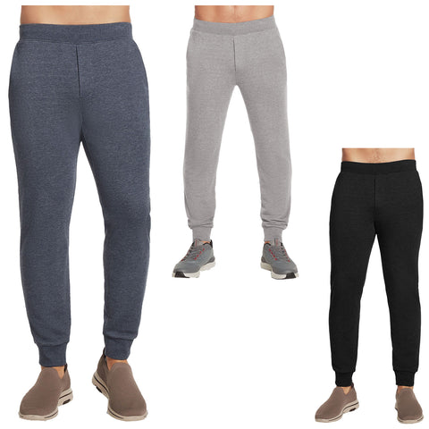 Three pairs of jogger pants in varying colors grey dark blue and black are displayed on a neutral background showcasing their casual style suitable for athletic or leisure activities