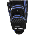 A black golf bag with blue accents stands upright featuring multiple zippered pockets and a strap for carrying in a golf course or sports environment