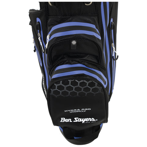 A black golf bag with blue accents stands upright featuring multiple zippered pockets and a strap for carrying in a golf course or sports environment