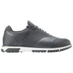 A grey shoe designed for walking features a sleek finish and textured accents with a white midsole and black rubber outsole situated on a plain white background.
