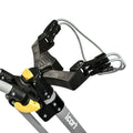 A black plastic device with grips and a yellow push button holds a lightweight aluminum frame used for securing items in a transportation context like a cart or luggage system.