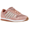 A pink sneaker with mesh and suede materials features silver stripes and a textured rubber sole positioned on a flat surface showcasing a sporty and casual design.