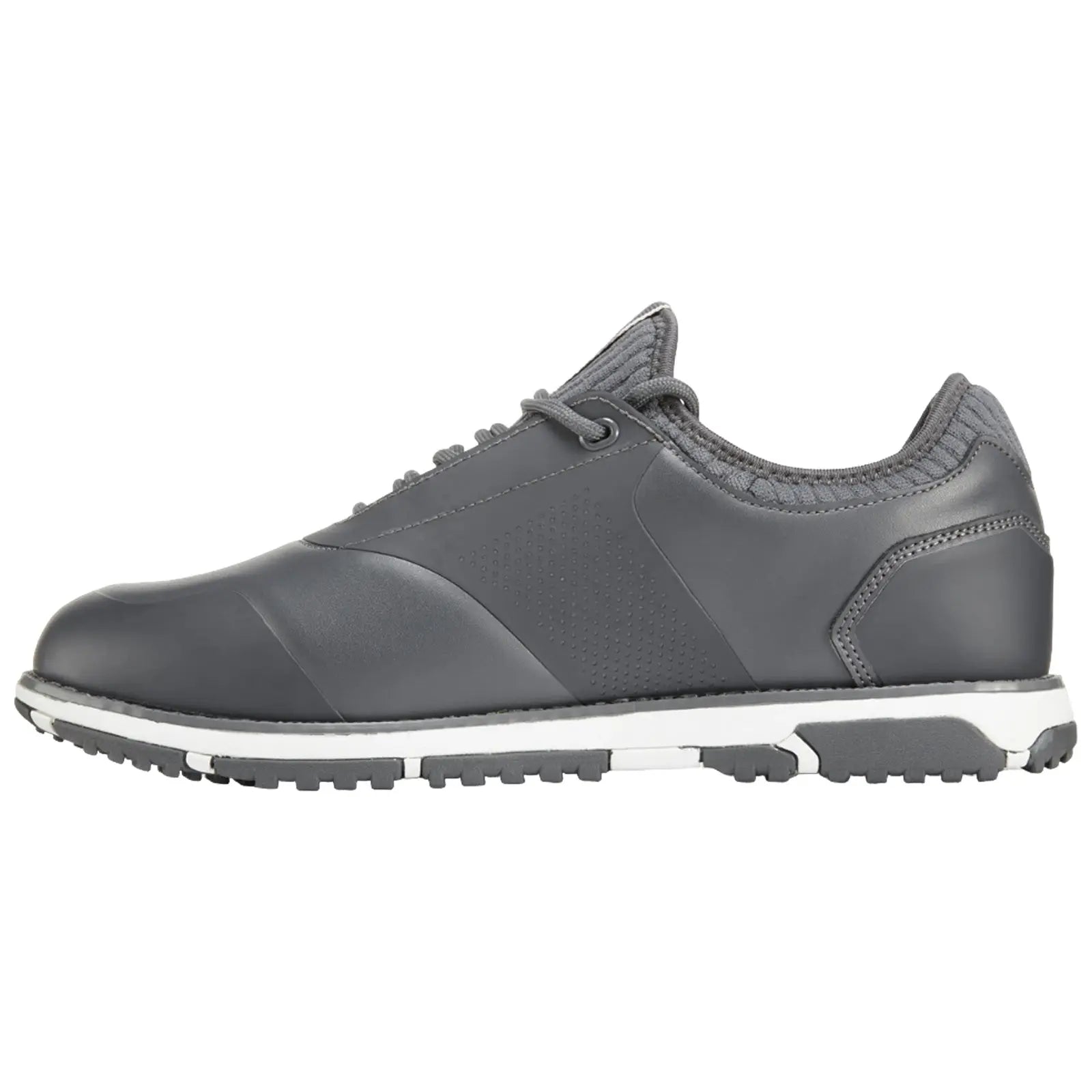 A gray athletic shoe sits on a flat surface featuring a smooth leather upper and textured accents with a white midsole and a patterned rubber outsole designed for traction.