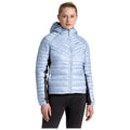 A woman is wearing a light blue puffy jacket with a hood and black accents standing confidently with her hands relaxed at her sides in a neutral setting.